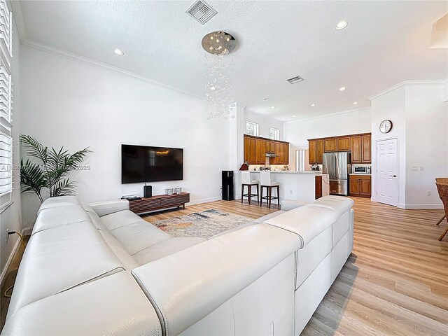 4268 SW 141st Ave, Davie, FL 33330 - living area with light wood-style flooring, ornamental molding, recessed lighting, and a textured ceiling