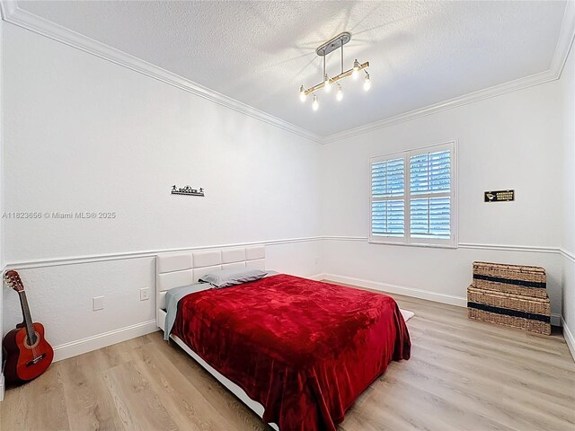 4268 SW 141st Ave, Davie, FL 33330 - bedroom with ornamental molding, wood finished floors, and a textured ceiling