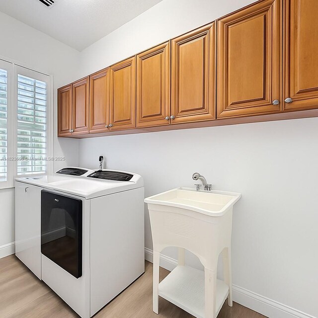 4268 SW 141st Ave, Davie, FL 33330 - laundry area with independent washer and dryer, light wood-style floors, and cabinet space