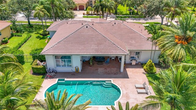 4268 SW 141st Ave, Davie, FL 33330 - back of house featuring a tiled roof, stucco siding, and a patio area