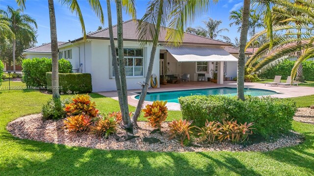 4268 SW 141st Ave, Davie, FL 33330 - back of property with a patio, an outdoor pool, stucco siding, and a tiled roof