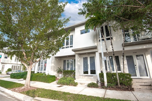 10555 NW 64th Way, Doral, FL 33178 - view of property with french doors and stucco siding