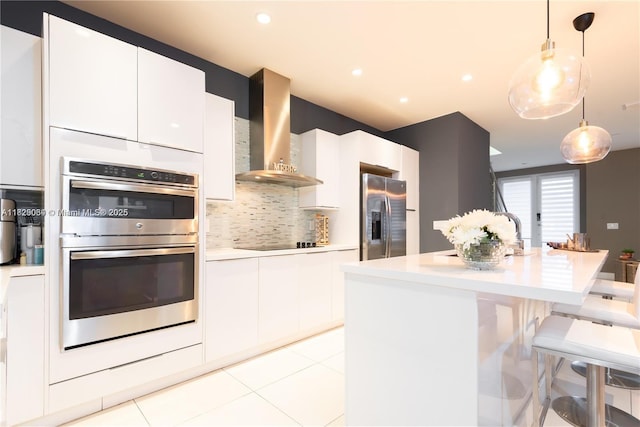 10555 NW 64th Way, Doral, FL 33178 - kitchen with stainless steel appliances, wall chimney exhaust hood, light countertops, white cabinetry, and backsplash