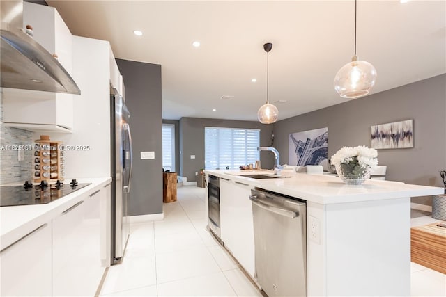 10555 NW 64th Way, Doral, FL 33178 - kitchen with appliances with stainless steel finishes, wall chimney exhaust hood, a kitchen island with sink, white cabinetry, and recessed lighting