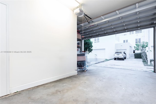 10555 NW 64th Way, Doral, FL 33178 - garage featuring a garage door opener and baseboards