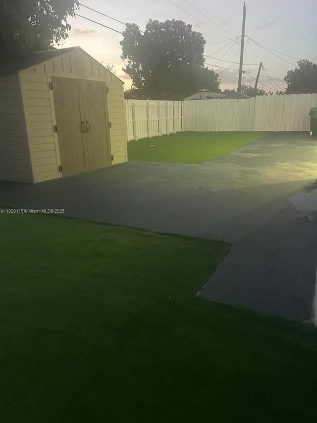 9020 NW 32nd Ave, Miami, FL 33147 - fenced backyard featuring a storage unit and a patio
