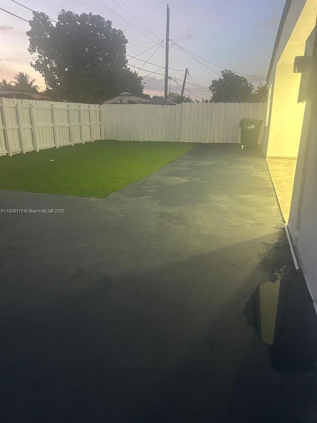 9020 NW 32nd Ave, Miami, FL 33147 - yard at dusk with a fenced backyard and a patio