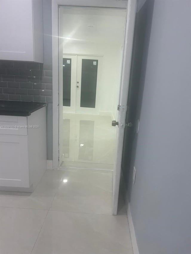 9020 NW 32nd Ave, Miami, FL 33147 - corridor with light tile patterned floors and baseboards