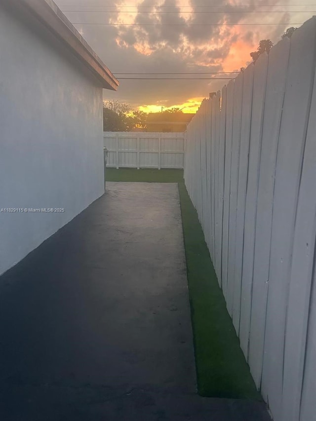 9020 NW 32nd Ave, Miami, FL 33147 - yard at dusk with a fenced backyard and a patio area