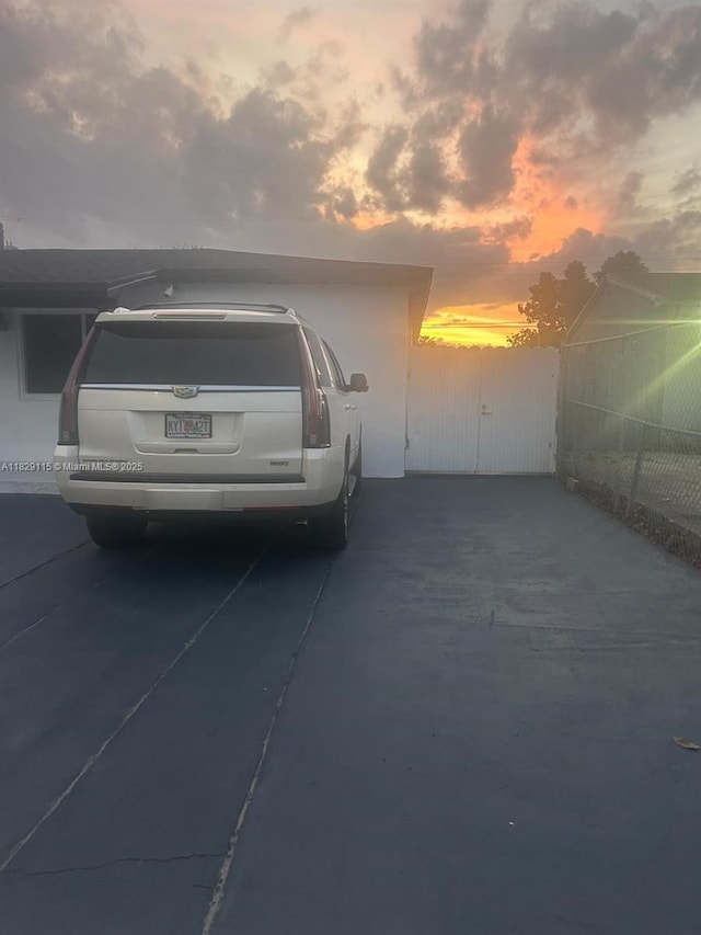 9020 NW 32nd Ave, Miami, FL 33147 - garage at dusk featuring concrete driveway