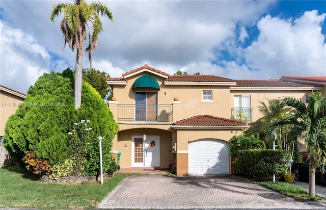 7081 SW 158th Ct, Miami, FL 33193 - mediterranean / spanish home featuring a balcony, stucco siding, a tile roof, decorative driveway, and a garage