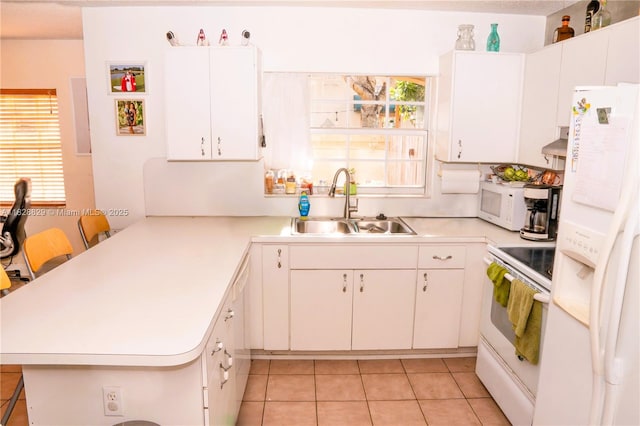7081 SW 158th Ct, Miami, FL 33193 - kitchen with white appliances, a peninsula, light countertops, and light tile patterned flooring