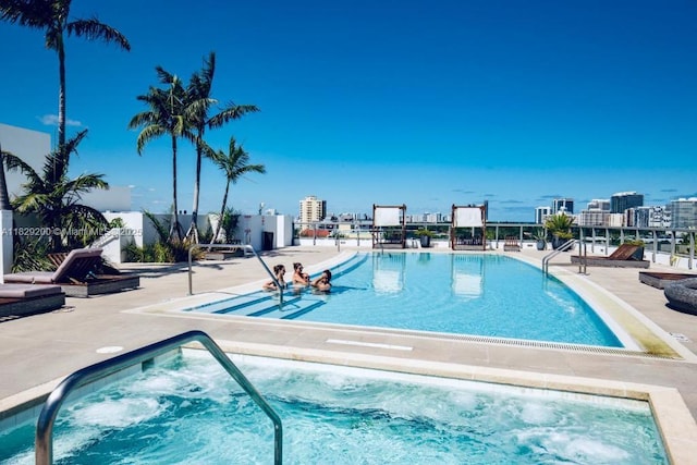 9261 E Bay Harbor Dr Unit 402, Bay Harbor Islands, FL 33154 - community pool featuring a hot tub and a patio area