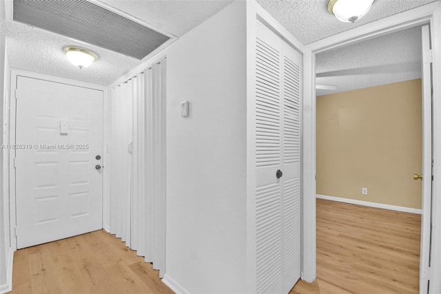 10501 W Broward Blvd Unit 304, Plantation, FL 33324 - hall featuring a textured ceiling and light wood-style floors