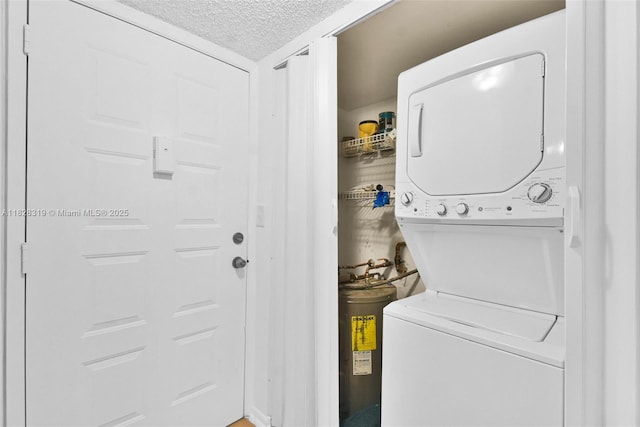 10501 W Broward Blvd Unit 304, Plantation, FL 33324 - laundry room featuring estacked washer and dryer and a textured ceiling