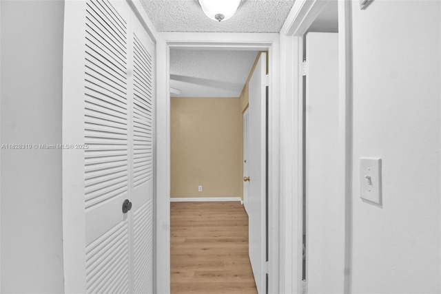 10501 W Broward Blvd Unit 304, Plantation, FL 33324 - corridor featuring a textured ceiling and light wood finished floors