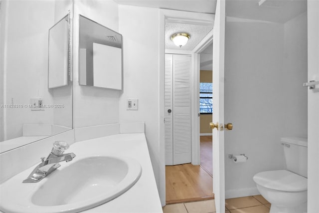 10501 W Broward Blvd Unit 304, Plantation, FL 33324 - bathroom with tile patterned flooring, a closet, vanity, and a textured ceiling