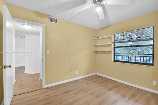 10501 W Broward Blvd Unit 304, Plantation, FL 33324 - spare room featuring a textured ceiling, light wood-type flooring, and a ceiling fan
