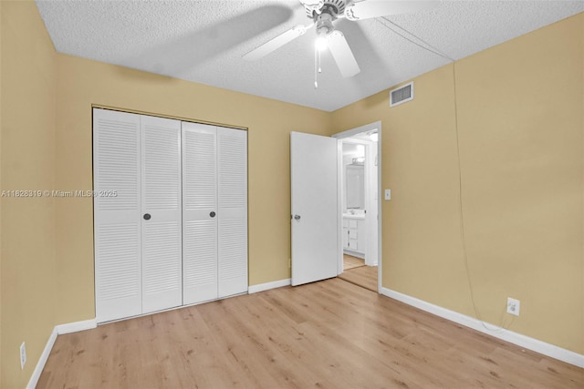 10501 W Broward Blvd Unit 304, Plantation, FL 33324 - unfurnished bedroom with light wood-style floors, a closet, a ceiling fan, and a textured ceiling