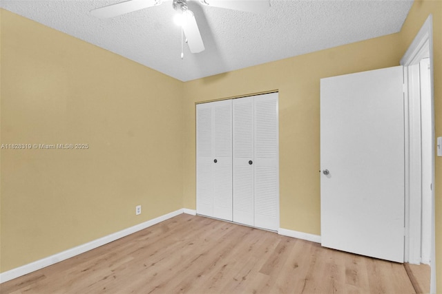 10501 W Broward Blvd Unit 304, Plantation, FL 33324 - unfurnished bedroom with light wood-style flooring, a closet, a textured ceiling, and a ceiling fan