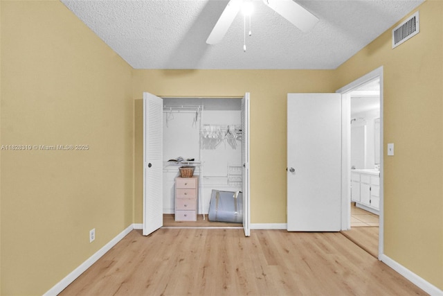 10501 W Broward Blvd Unit 304, Plantation, FL 33324 - unfurnished bedroom with wood finished floors, a closet, a textured ceiling, and a ceiling fan