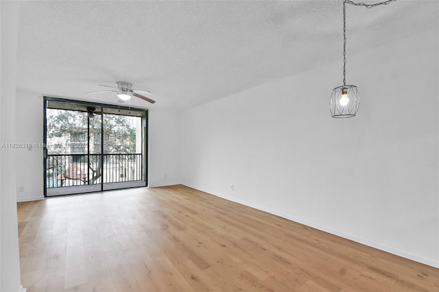 10501 W Broward Blvd Unit 304, Plantation, FL 33324 - unfurnished room with light wood finished floors, a ceiling fan, and a textured ceiling