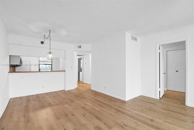 10501 W Broward Blvd Unit 304, Plantation, FL 33324 - unfurnished living room featuring wood finished floors and a textured ceiling