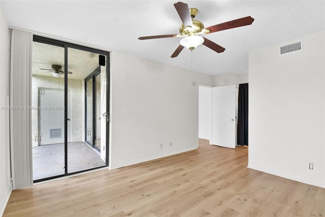 10501 W Broward Blvd Unit 304, Plantation, FL 33324 - spare room featuring a ceiling fan, a wall of windows, and wood finished floors