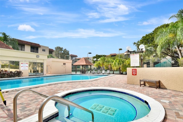 10501 W Broward Blvd Unit 304, Plantation, FL 33324 - community pool with a gazebo, a community hot tub, and a patio
