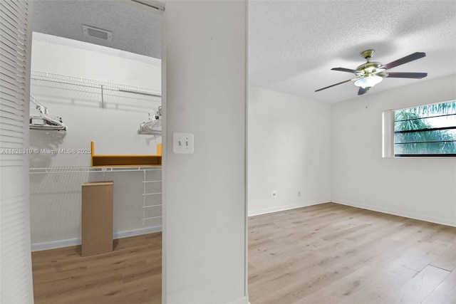 10501 W Broward Blvd Unit 304, Plantation, FL 33324 - spare room featuring wood finished floors, a textured ceiling, and ceiling fan