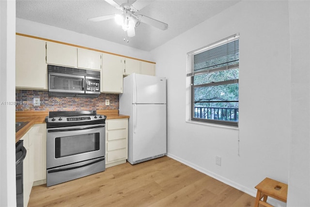 10501 W Broward Blvd Unit 304, Plantation, FL 33324 - kitchen featuring appliances with stainless steel finishes, decorative backsplash, light wood finished floors, and ceiling fan
