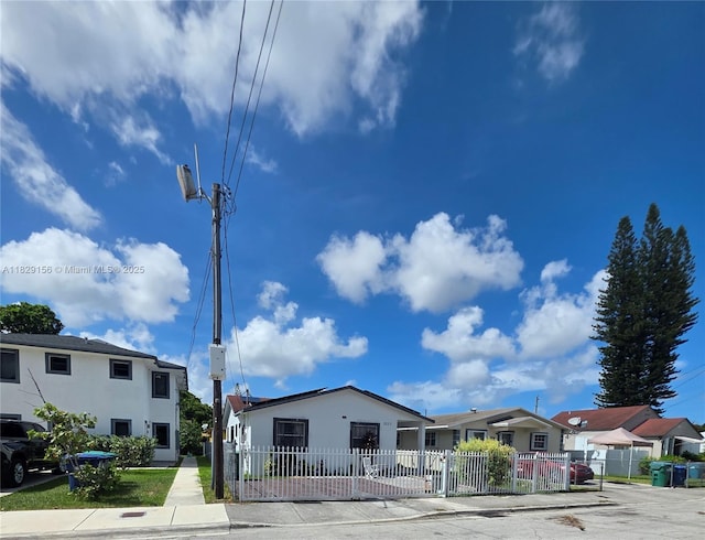 2237 NW 50th St, Miami, FL 33142 - view of front of house featuring stucco siding, a fenced front yard, and a residential view