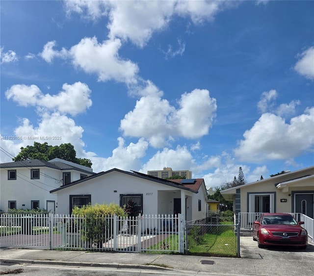 2237 NW 50th St, Miami, FL 33142 - view of front of house with a fenced front yard and stucco siding
