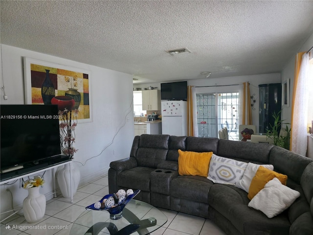 2237 NW 50th St, Miami, FL 33142 - living room featuring a textured ceiling and light tile patterned floors