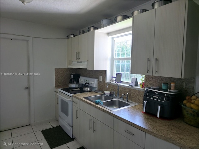 2237 NW 50th St, Miami, FL 33142 - kitchen featuring white range with electric stovetop, under cabinet range hood, decorative backsplash, light tile patterned floors, and light countertops