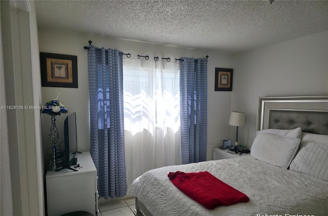 2237 NW 50th St, Miami, FL 33142 - bedroom with a textured ceiling and light tile patterned floors