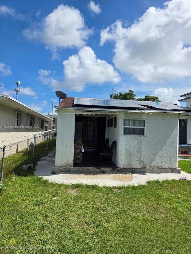 2237 NW 50th St, Miami, FL 33142 - back of house with solar panels and stucco siding
