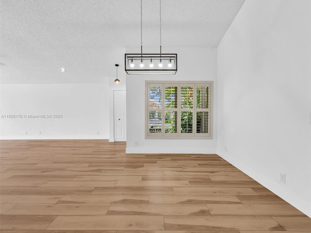 10370 NW 11th St, Plantation, FL 33322 - unfurnished dining area featuring light wood-style floors and a textured ceiling