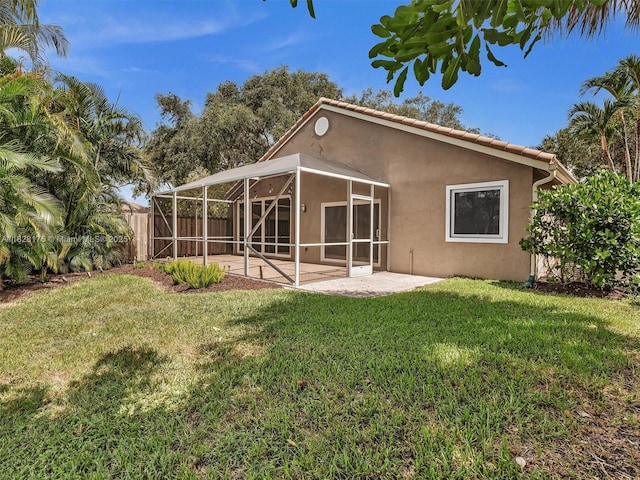 10370 NW 11th St, Plantation, FL 33322 - back of property with stucco siding, a patio, a fenced backyard, and a lanai