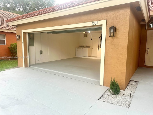 1084 Aspri Way, Riviera Beach, FL 33418 - garage featuring separate washer and dryer and driveway