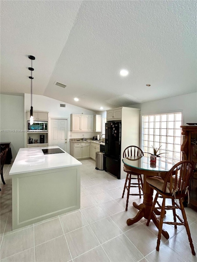 1084 Aspri Way, Riviera Beach, FL 33418 - kitchen featuring black appliances, a textured ceiling, vaulted ceiling, light countertops, and recessed lighting