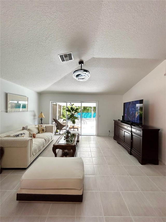 1084 Aspri Way, Riviera Beach, FL 33418 - living room featuring a textured ceiling, light tile patterned flooring, and vaulted ceiling