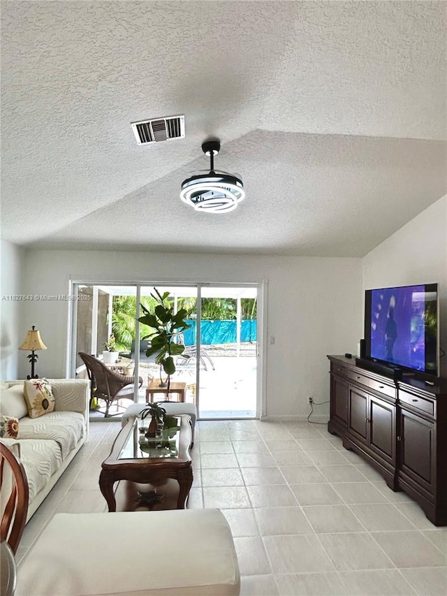 1084 Aspri Way, Riviera Beach, FL 33418 - living room with a textured ceiling and light tile patterned floors