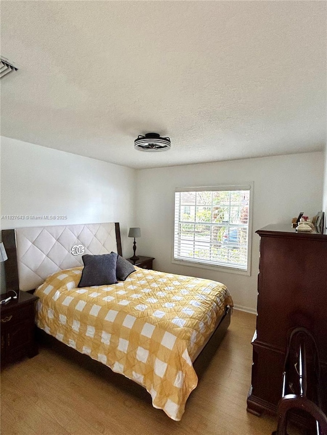 1084 Aspri Way, Riviera Beach, FL 33418 - bedroom with wood finished floors and a textured ceiling