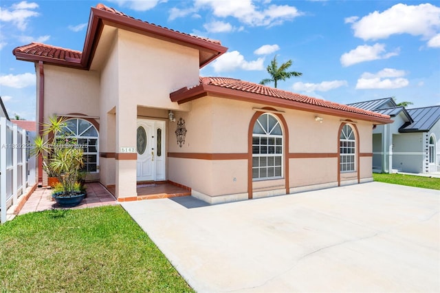 5143 SW 142nd Pl, Miami, FL 33175 - mediterranean / spanish-style home featuring stucco siding, a tiled roof, and a patio