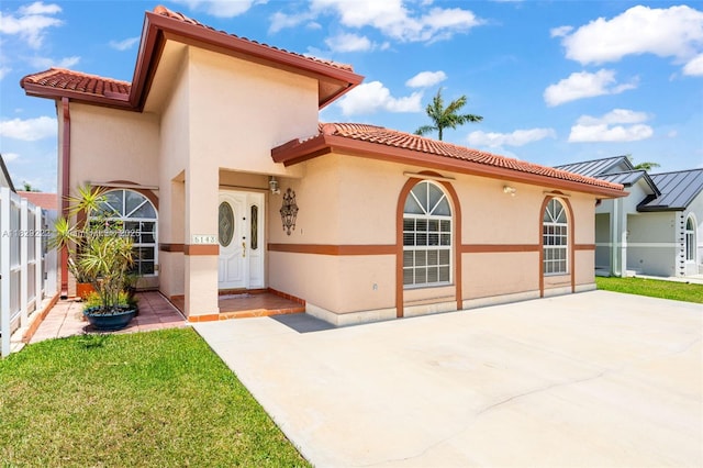 5143 SW 142nd Pl, Miami, FL 33175 - mediterranean / spanish-style home with stucco siding, a tiled roof, and a patio area