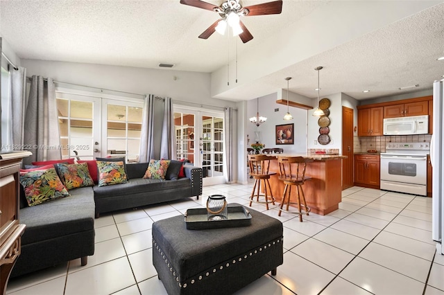 5143 SW 142nd Pl, Miami, FL 33175 - living room featuring french doors, a textured ceiling, lofted ceiling, a ceiling fan, and light tile patterned floors
