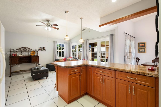 5143 SW 142nd Pl, Miami, FL 33175 - kitchen featuring a ceiling fan, brown cabinets, pendant lighting, light stone countertops, and french doors