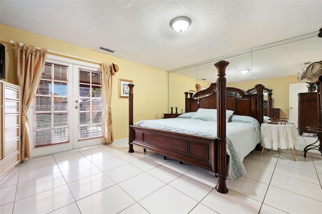5143 SW 142nd Pl, Miami, FL 33175 - bedroom featuring french doors, access to exterior, light tile patterned floors, and a textured ceiling