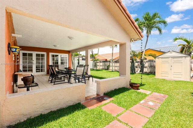 5143 SW 142nd Pl, Miami, FL 33175 - fenced backyard with french doors, a shed, and a patio area
